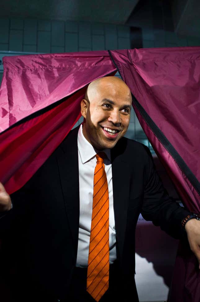Booker emerges from the voting booth in Newark.