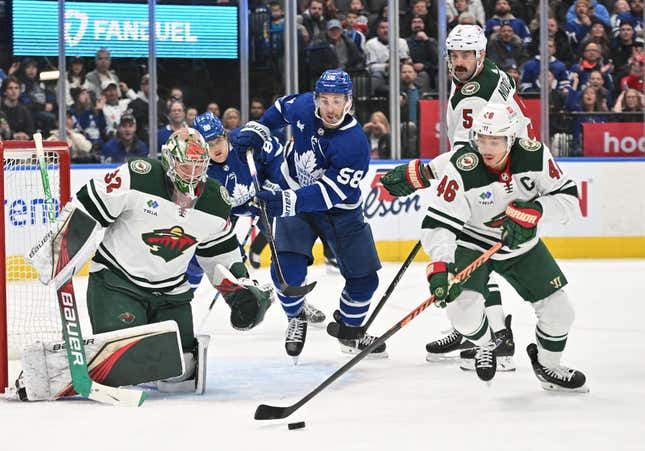 Feb 24, 2023; Toronto, Ontario, CAN;   Minnesota Wild goalie Filip Gustavsson (32) watches defenseman Jared Spurgeon (46) clear out a rebound after a save on Toronto Maple Leafs forward Michael Bunting (58) in the first period at Scotiabank Arena.