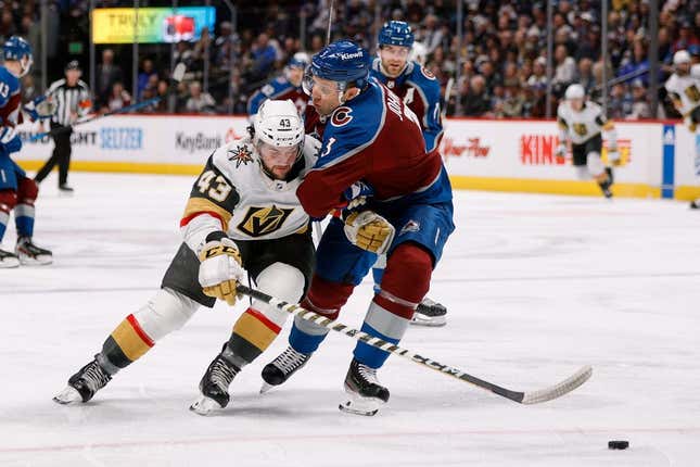 Feb 27, 2023; Denver, Colorado, USA; Vegas Golden Knights center Paul Cotter (43) and Colorado Avalanche defenseman Jack Johnson (3) battle for the puck in the first period at Ball Arena.