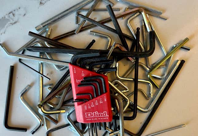A pile of Allen wrenches on a marble countertop.