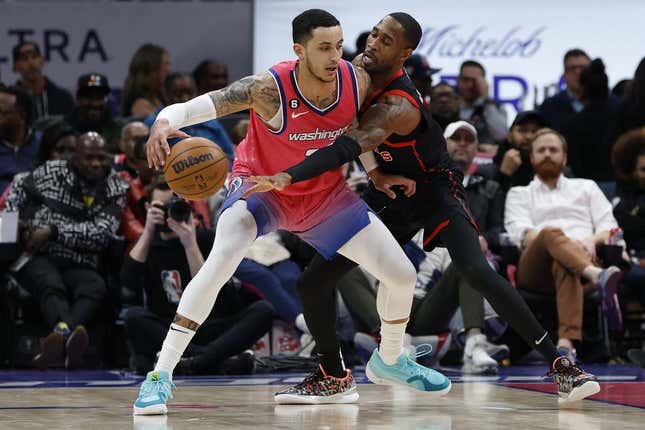 Mar 2, 2023; Washington, District of Columbia, USA; Washington Wizards forward Kyle Kuzma (33) drives to the basket as guard Will Barton (7) defends in the second quarter at Capital One Arena.