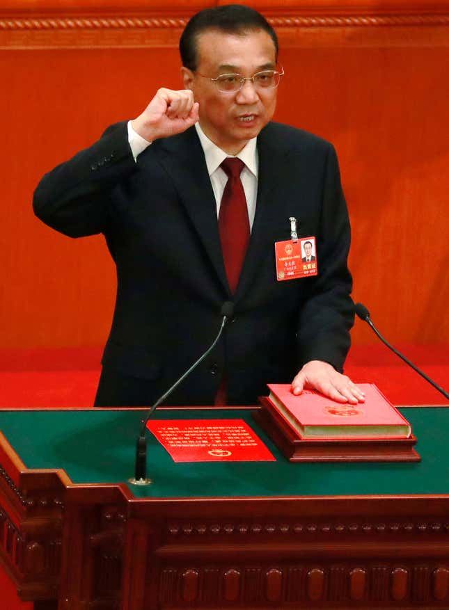 Chinese Premier Li Keqiang swears an oath with his hand on the constitution after being re-elected as premier at the 6th plenary session of the first session of the 13th National People's Congress (NPC) at the Great Hall of the People in Beijing, China, 18 March 2018. Delegates of the NPC vote on 18 March to decide on the appointment of the premier, and vice chairpersons of the Central Military Commission (CMC). The NPC has over 3,000 delegates and is the world's largest parliament or legislative assembly though its function is largely as a formal seal of approval for the policies fixed by the leaders of the Chinese Communist Party. The NPC runs alongside the annual plenary meetings of the Chinese People's Political Consultative Conference (CPPCC), together known as 'Lianghui' or 'Two Meetings'.