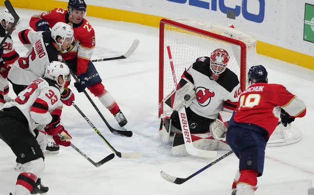 Mar 18, 2023; Sunrise, Florida, USA;  New Jersey Devils goaltender Akira Schmid (40) makes a save on a shot by Florida Panthers left wing Matthew Tkachuk (19) in the second period at FLA Live Arena.