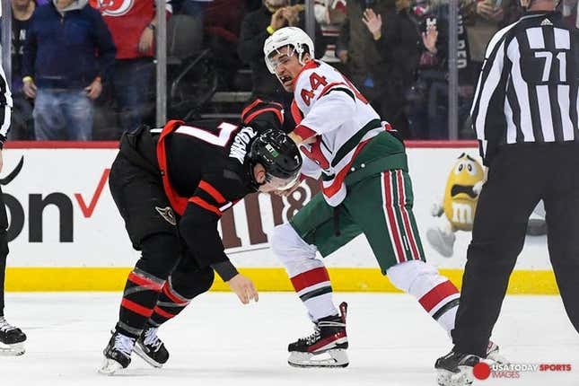 Mar 25, 2023; Newark, New Jersey, USA;  New Jersey Devils left wing Miles Wood (44) and Ottawa Senators left wing Brady Tkachuk (7) fight during the first period at Prudential Center.