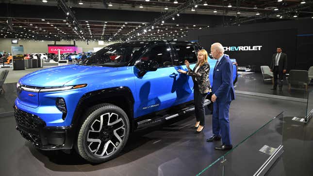 U.S. President Joe Biden and GM CEO Mary Barra look at a Chevrolet Silverado EV at NAIAS.