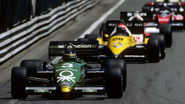 A photo of a green Tyrrell F1 car leading the pack in Detroit. 