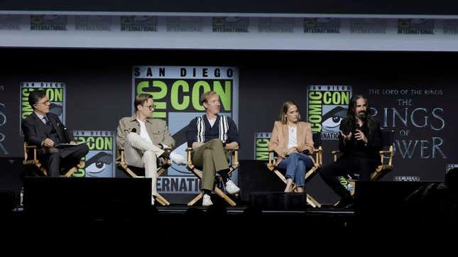 five people sitting on stage