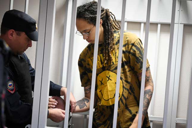 A policeman removes the handcuffs from WNBA star and two-time Olympic gold medalist Brittney Griner in a courtroom prior to a hearing in the Khimki district court, just outside Moscow, Russia, Friday, July 15, 2022.