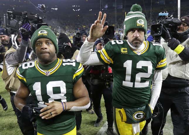 Jan 8, 2023; Green Bay, Wisconsin, USA; Green Bay Packers wide receiver Randall Cobb (18) and quarterback Aaron Rodgers (12) leave the field together after losing to the Detroit Lions at Lambeau Field.
