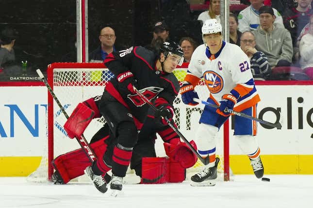 Apr 2, 2023; Raleigh, North Carolina, USA;  Carolina Hurricanes defenseman Brady Skjei (76) clears the puck away from New York Islanders left wing Anders Lee (27) on the penalty kill during the first period at PNC Arena.