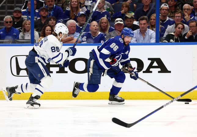 Apr 22, 2023; Tampa, Florida, USA; Tampa Bay Lightning right wing Nikita Kucherov (86) skates with the puck against Toronto Maple Leafs right wing William Nylander (88) during the third period in game three of the first round of the 2023 Stanley Cup Playoffs at Amalie Arena.