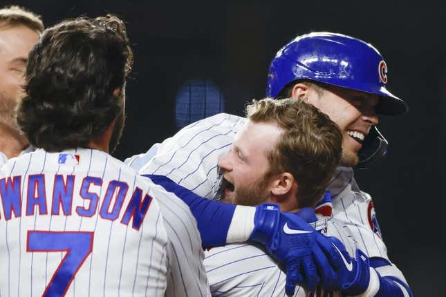 Apr 10, 2023; Chicago, Illinois, USA; Chicago Cubs second baseman Nico Hoerner (2) celebrates with teammates after hitting game winning single against the Seattle Mariners during the 10th inning at Wrigley Field.