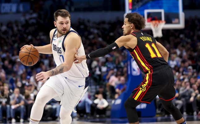 Jan 18, 2023; Dallas, Texas, USA; Dallas Mavericks guard Luka Doncic (77) drives to the basket as Atlanta Hawks guard Trae Young (11) defends during the second half at American Airlines Center.
