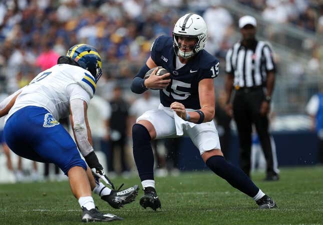 Sep 9, 2023; University Park, Pennsylvania, USA; Penn State Nittany Lions quarterback Drew Allar (15) looks to avoid a tackle while running with the ball during the first quarter against the Delaware Fightin&#39; Blue Hens at Beaver Stadium.