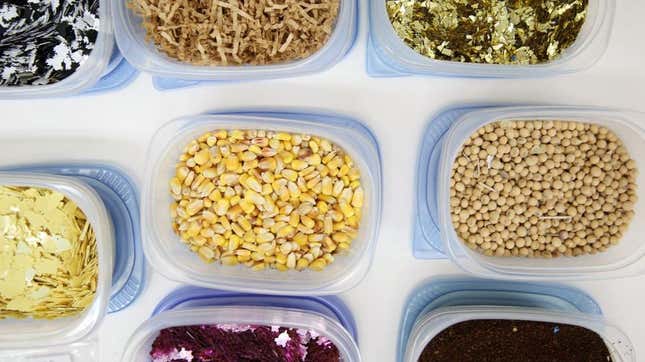 Corn, beans and other foods in separate plastic Tupperware containers