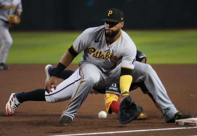 July 9, 2023; Phoenix, AZ, USA; Pittsburgh Pirates&#39; Carlos Santana (41) catches the ball at first base as Arizona Diamondbacks Geraldo Perdomo (2) slides in safely at Chase Field.