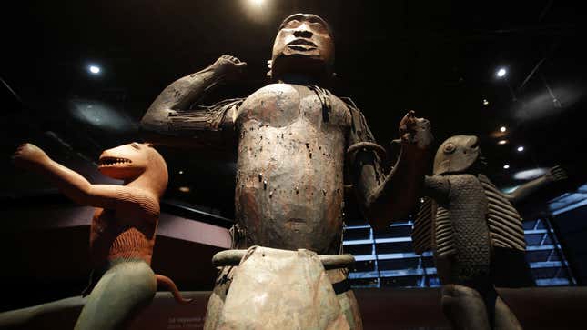 Three large royal statues of the Kingdom of Dahomey are displayed at the Quai Branly Museum in Paris, France