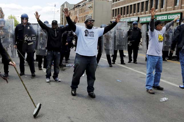 Community members stand between protestors and law enforcement. (Reuters/Jim Bourg)