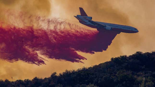 A photo of a DC-10 tanker dropping fire retardant. 