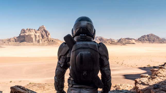 Paul Atreides, in his stillsuit, looks over the desert plains of Arrakis.
