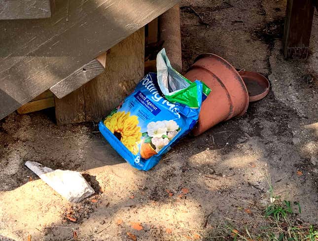 Image for article titled Two-Thirds Full Bag Of Potting Soil Forever Banished To Area Under Porch
