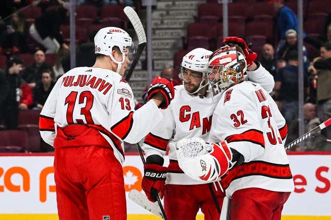 Apr 1, 2023; Montreal, Quebec, CAN; Carolina Hurricanes goalie Antti Raanta (32) celebrates the win against the Montreal Canadiens with right wing Jesse Puljujarvi (13) and defenseman Shayne Gostisbehere (41) after the third period at Bell Centre.