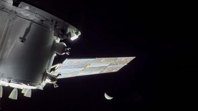 An image taken by an onboard camera shows the Artemis spacecraft and the Moon.