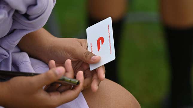 A woman holds a gift card 