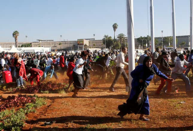 Aviation workers and passengers are dispersed by riot police officers at the Jomo Kenyatta International Airport during a labour dispute that grounded flights, near Nairobi, Kenya March 6, 2019.