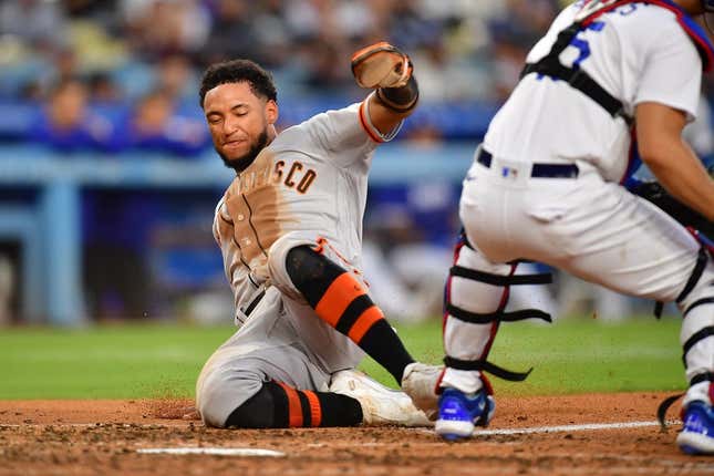 Jun 17, 2023; Los Angeles, California, USA; San Francisco Giants center fielder Luis Matos (29) scores a run against the Los Angeles Dodgers during the seventh inning at Dodger Stadium.