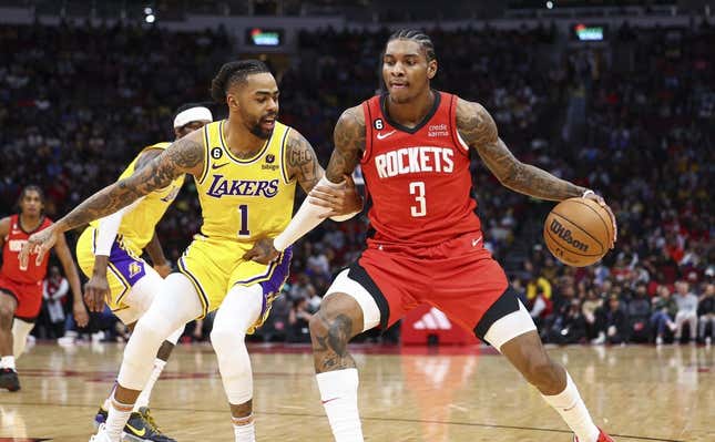 Mar 15, 2023; Houston, Texas, USA; Houston Rockets guard Kevin Porter Jr. (3) controls the ball as Los Angeles Lakers guard D&#39;Angelo Russell (1) defends during the second quarter at Toyota Center.