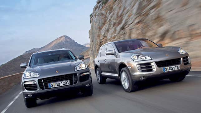 A photo of two Porsche Cayenne SUVs driving on a highway. 