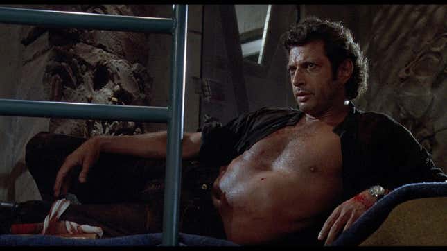 Jeff Goldblum's Dr. Ian Malcolm lounges with his black shirt open in a classic scene from Jurassic Park.
