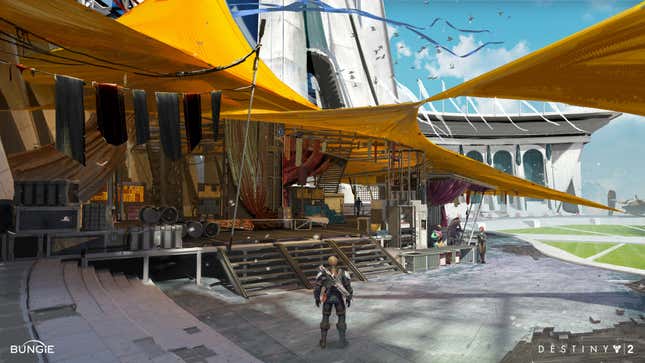 A Guardian stands nears some merchant stalls in Destiny 2's Tower.