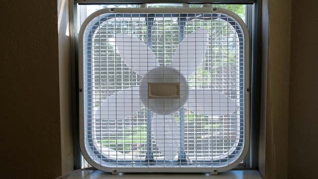 A box fan sitting in a windo