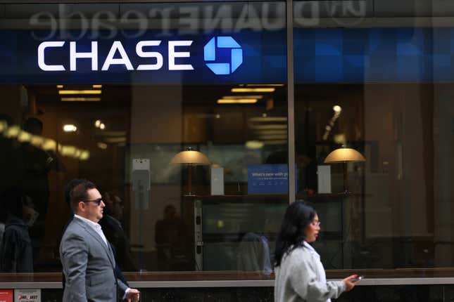 Two people walk past a Chase branch in New York City.