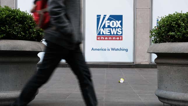 People walk by the News Corporation headquarters, home to Fox News, on April 18, 2023 in New York City. Moments before opening arguments were set to begin this afternoon, Fox News and Dominion Voting Systems said that they had reached a settlement of $787 million in the voting machine company’s defamation lawsuit against Fox.