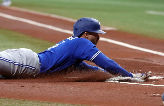 May 23, 2023; St. Petersburg, Florida, USA; Toronto Blue Jays right fielder George Springer (4) slides home to score a run  against the Tampa Bay Rays during the first inning at Tropicana Field.
