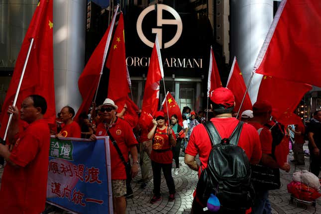 People march in the Tsim Sha Tsui shopping district to celebrate China’s National Day in Hong Kong on Oct. 1, 2016.