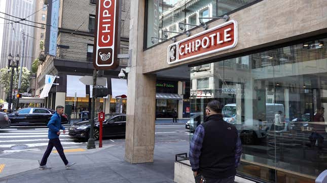 Pedestrians walk by a Chipotle restaurant on April 26, 2022 in San Francisco, California. 
