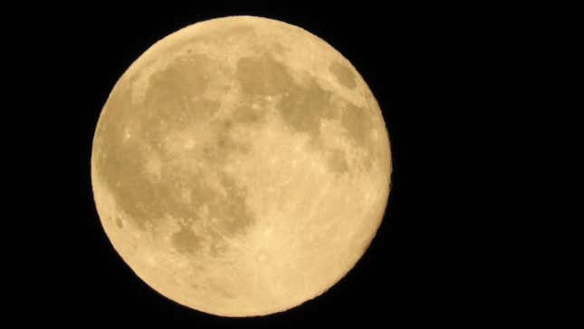 picture of june's strawberry moon against a pitch black sky