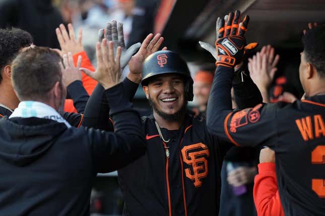 Sep 9, 2023; San Francisco, California, USA; San Francisco Giants second baseman Thairo Estrada (center) is congratulated by teammates after hitting a home run against the Colorado Rockies during the first inning at Oracle Park.