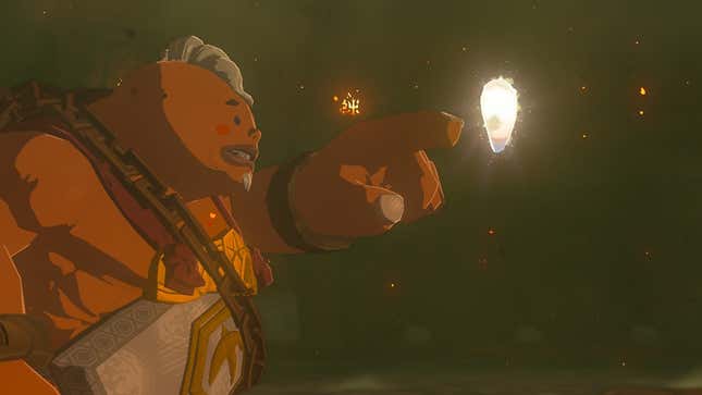 Yunobo is seen pointing at a floating, glowing gem.