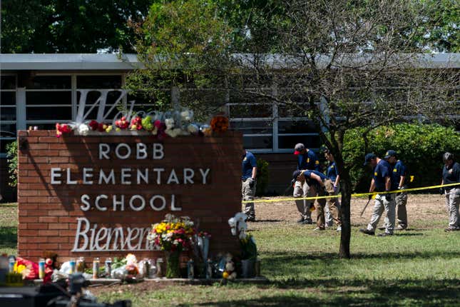 Investigators search for evidence outside Robb Elementary School in Uvalde, Texas, May 25, 2022, after an 18-year-old gunman killed 19 students and two teachers.