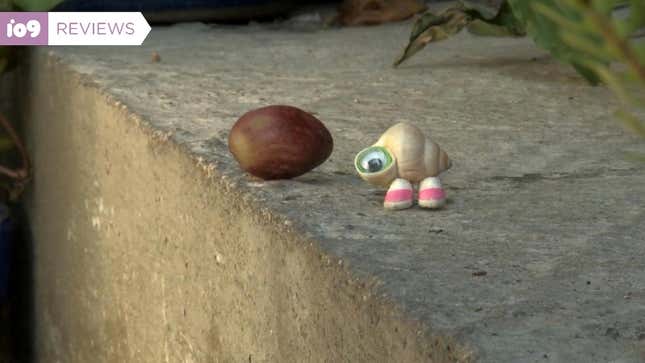 Marcel the Shell standing next to a nut.