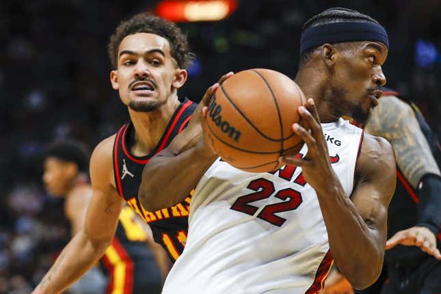 Jan 14, 2022; Miami, Florida, USA; Miami Heat forward Jimmy Butler (22) protects the ball from Atlanta Hawks guard Trae Young (11) during the second quarter of the game at FTX Arena.