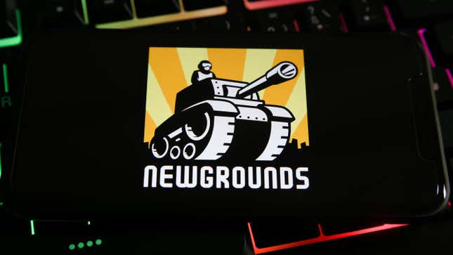 A phone with the newgrounds logo on top of a keyboard.