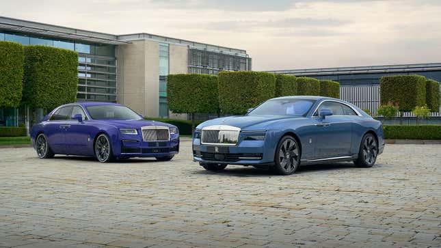 A photo of two Rolls Royce cars outside the factory. 