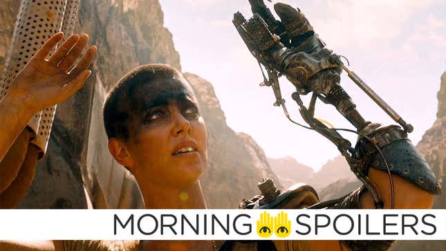 Charlize Theron's Furiosa raises her hands above her head in a scene from Mad Max: Fury Road.