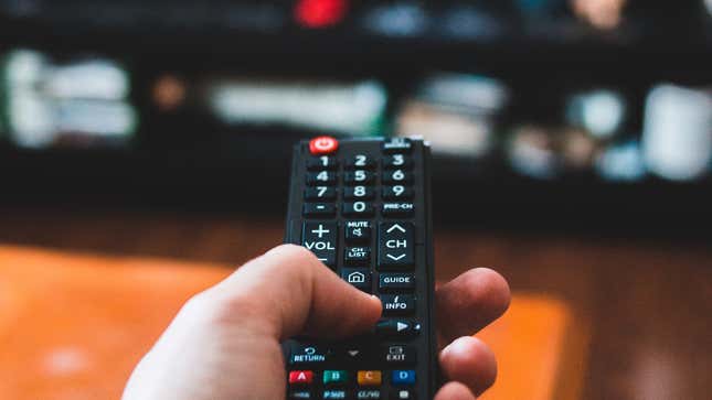 Photo of a hand holding a remote